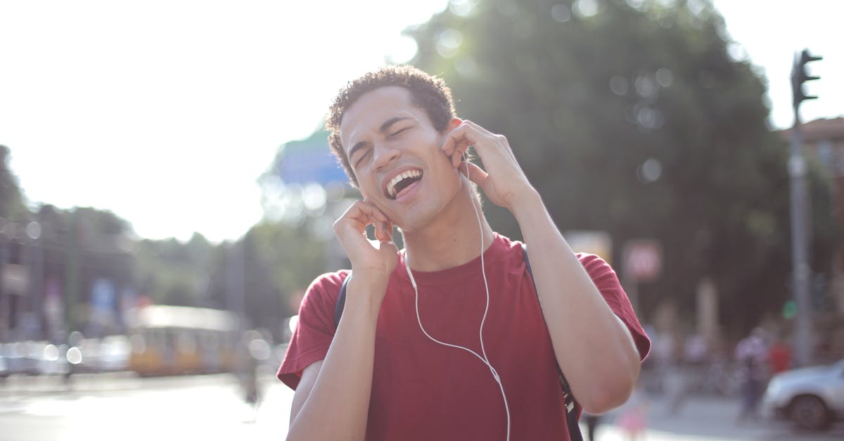 Oven does not have a temperature notification sound - Delighted African American young male in casual wear enjoying songs in earphones on street and singing along loudly while standing in city with closed eyes Oven does not have a temperature notification sound - Delighted African American young male in casual wear enjoying songs in earphones on street and singing along loudly while standing in city with closed eyes