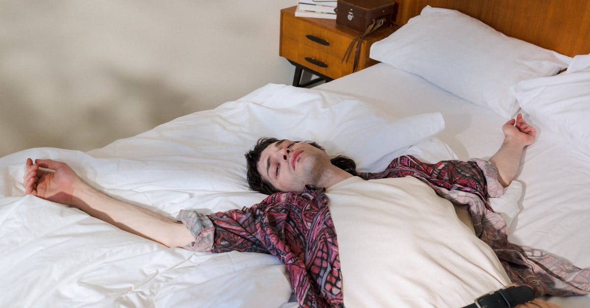 Oven is leaking steam out the back - Young Man Laying on Back in Bed and Chilling Out Oven is leaking steam out the back - Young Man Laying on Back in Bed and Chilling Out