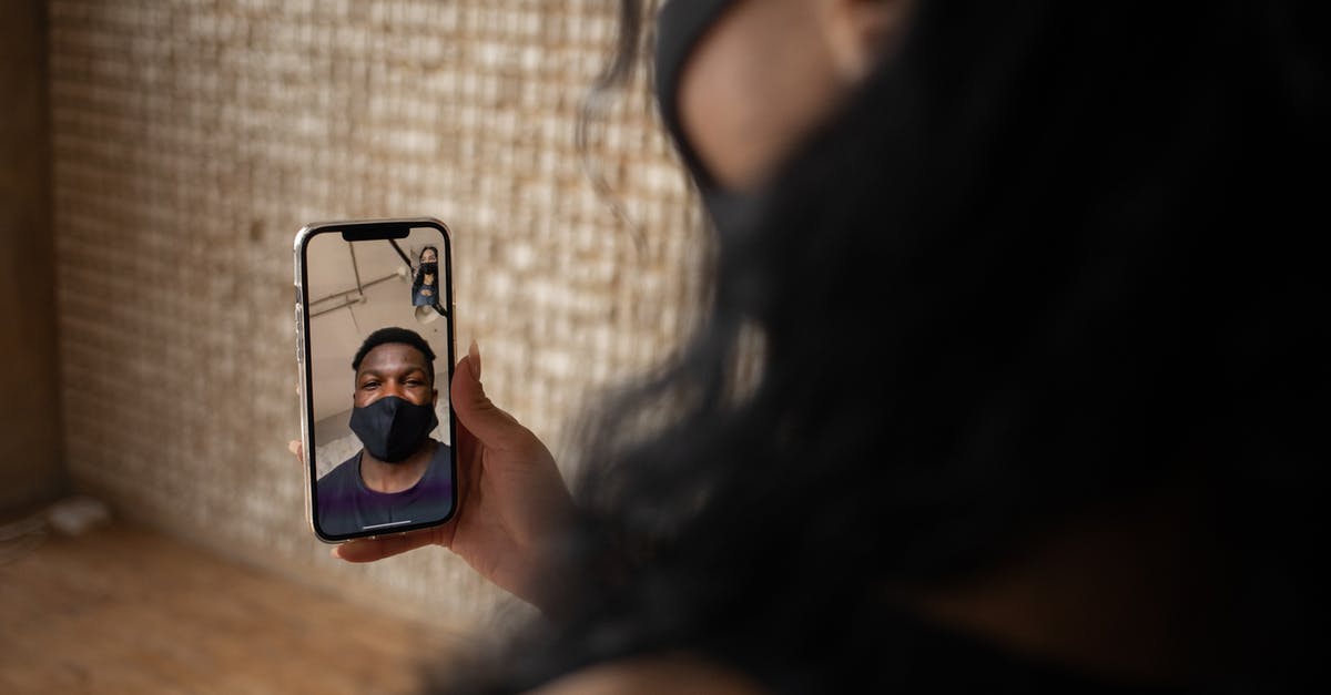Oxtail soup, what is the normal simmer time? - Back view of crop anonymous female talking to ethnic male beloved in fabric mask during video call on cellphone Oxtail soup, what is the normal simmer time? - Back view of crop anonymous female talking to ethnic male beloved in fabric mask during video call on cellphone