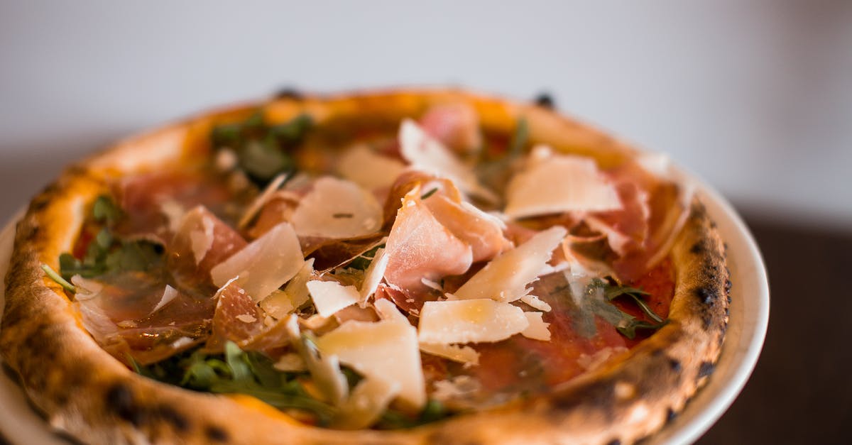 Parmesan regiano substitute - Pizza With Cheese and Green Leaves Parmesan regiano substitute - Pizza With Cheese and Green Leaves