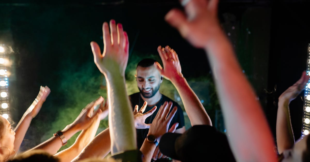 Party scale sous-vide - People Raising Their Hands during Nighttime Party scale sous-vide - People Raising Their Hands during Nighttime