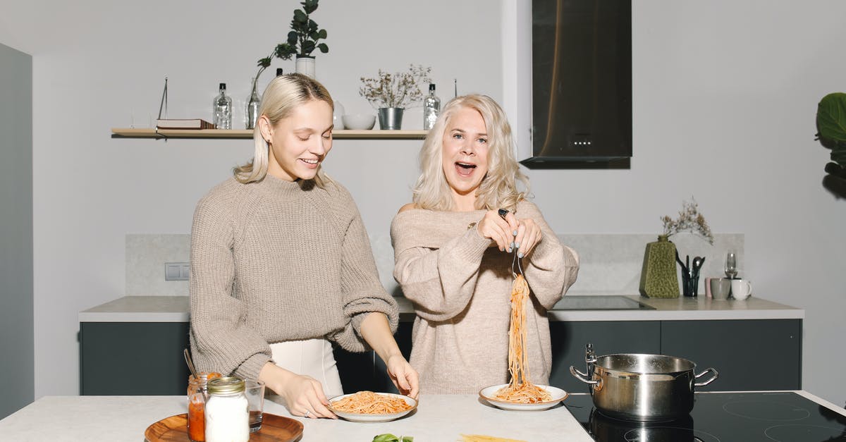 Pasta cooking time - Mother And Daughter Having Spaghetti For Meal Pasta cooking time - Mother And Daughter Having Spaghetti For Meal