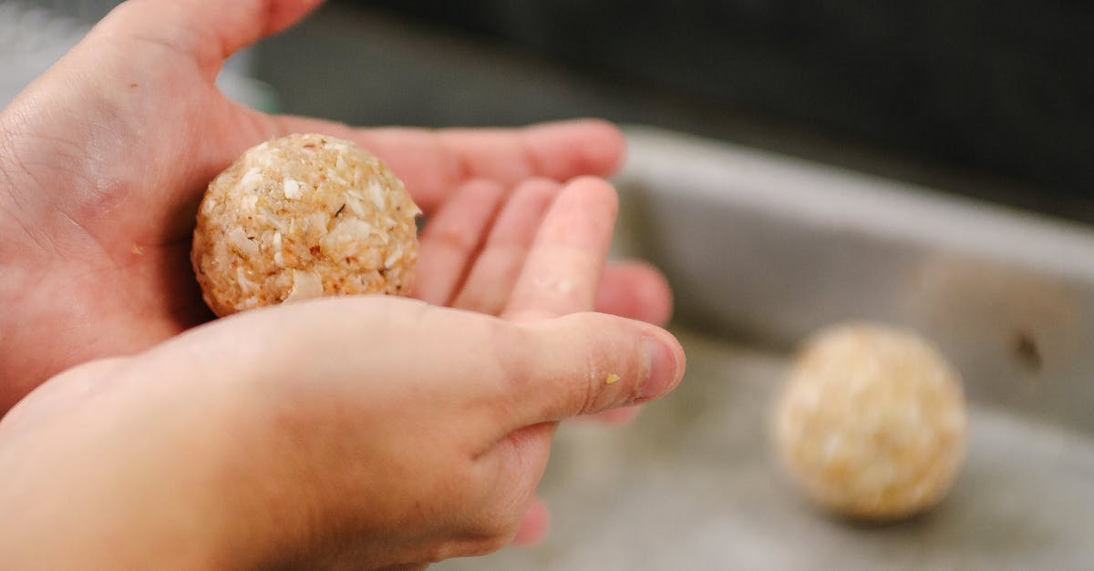 Pastry not "sticking" to beef Wellington - Crop faceless person showing delicious round meatballs in kitchen while cooking at home Pastry not "sticking" to beef Wellington - Crop faceless person showing delicious round meatballs in kitchen while cooking at home