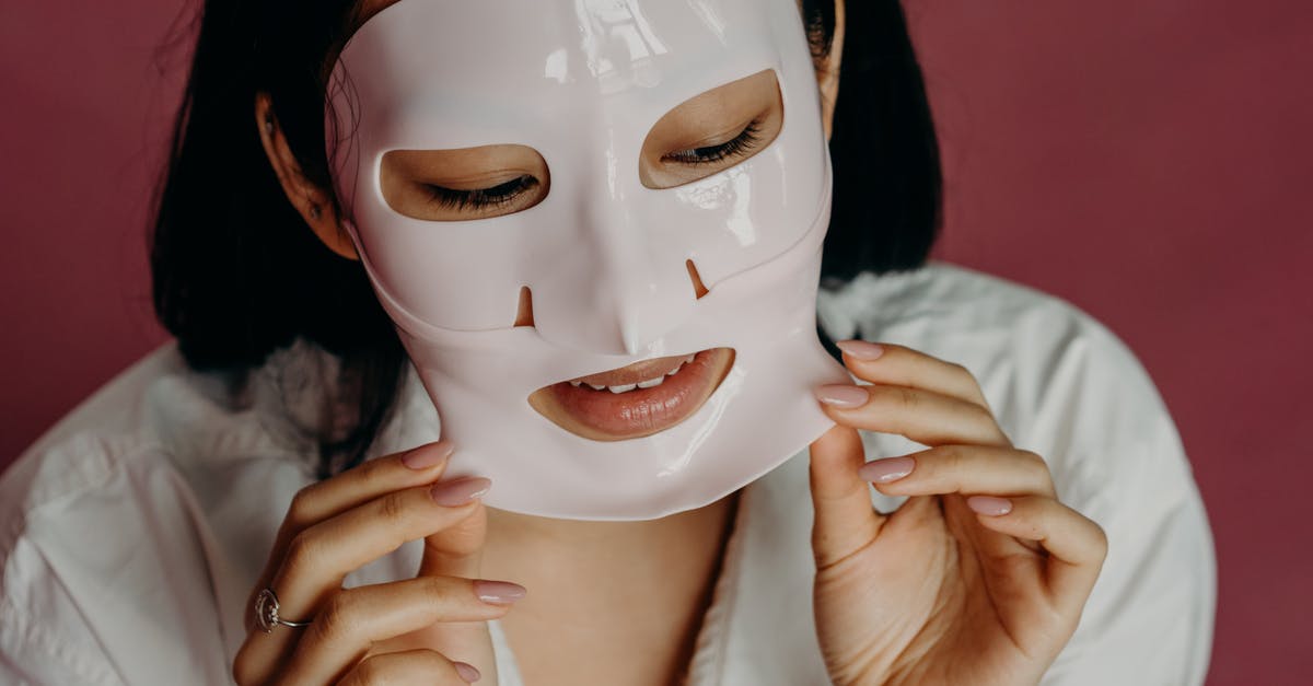 Peeling a Drumstick - A Woman in White Shirt Peeling Her Facial Mask Peeling a Drumstick - A Woman in White Shirt Peeling Her Facial Mask