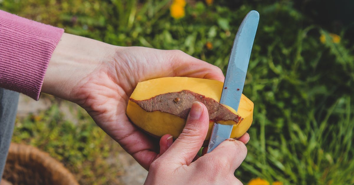 Peeling and dicing potato before boiling it - A Person Holding a Knife Peeling and dicing potato before boiling it - A Person Holding a Knife