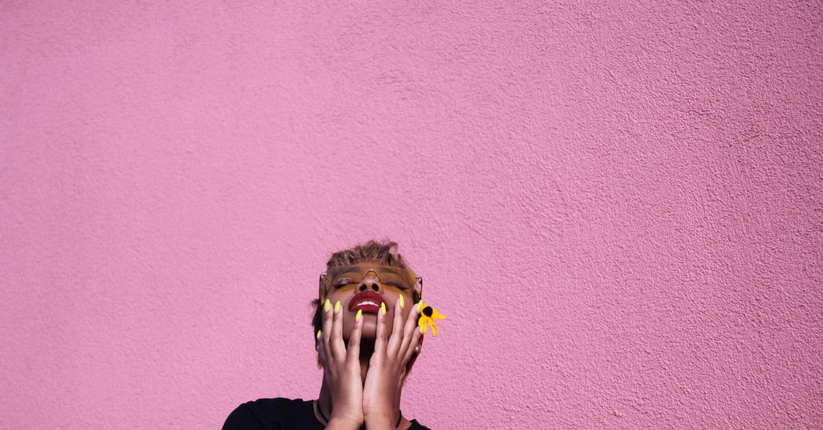 peeling black eyed peas for acaraje (fritters) - Stylish young African American female in casual wear and sunglasses with closed eyes touching face while throwing head back on pink background peeling black eyed peas for acaraje (fritters) - Stylish young African American female in casual wear and sunglasses with closed eyes touching face while throwing head back on pink background