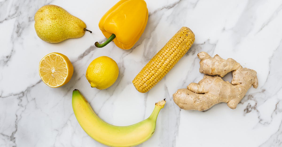 Pepperoncinis vs Banana Peppers - Fruits and Vegetables on the White Surface Pepperoncinis vs Banana Peppers - Fruits and Vegetables on the White Surface
