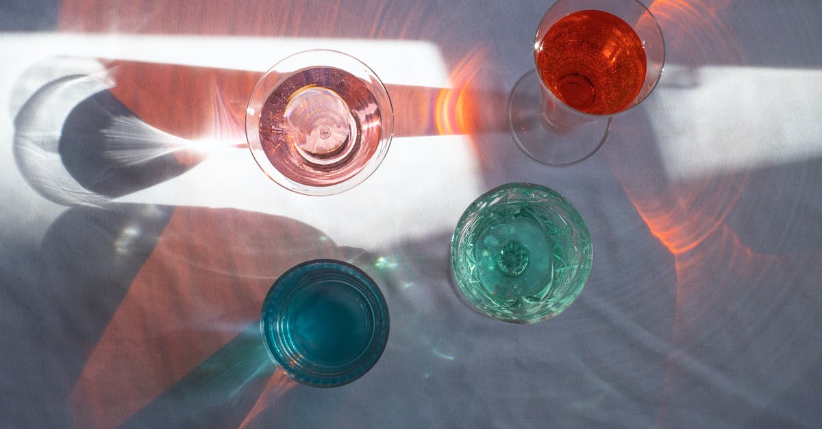 Pie with 2 different fillings - Top view of transparent glasses filled with different beverages and placed at sun beam Pie with 2 different fillings - Top view of transparent glasses filled with different beverages and placed at sun beam