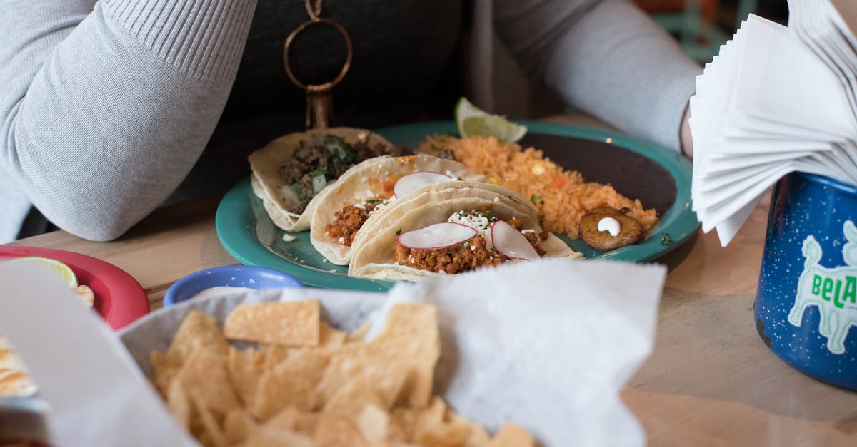 Pimento sauce that is added to mayo - Person Sitting in Front of Tacos on Plate Pimento sauce that is added to mayo - Person Sitting in Front of Tacos on Plate
