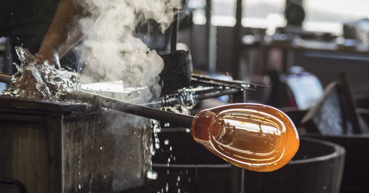 Plastic containers exposed to heat while cooking - Person in Black Shirt Holding Glass Rod Plastic containers exposed to heat while cooking - Person in Black Shirt Holding Glass Rod