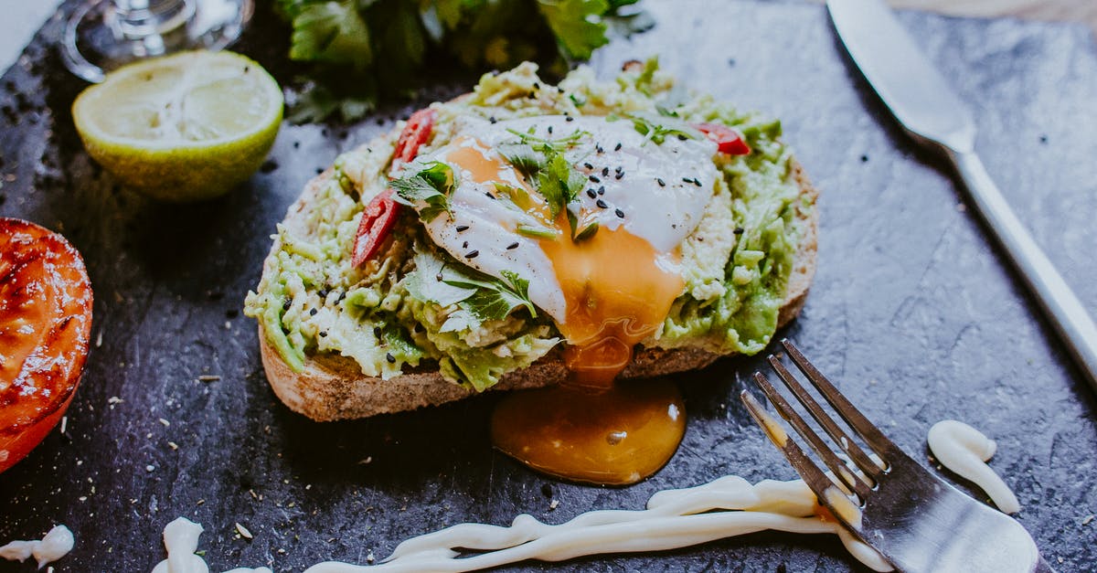 Poached eggs at altitude? - Delicious toast with poached egg for breakfast in restaurant Poached eggs at altitude? - Delicious toast with poached egg for breakfast in restaurant