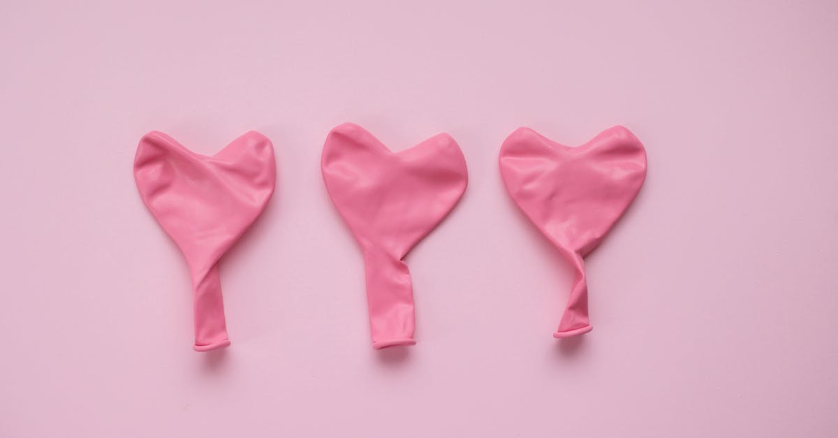 Poolish deflated after refrigeration - Top view of pink deflated balloons in form of hearts placed on pink background in studio Poolish deflated after refrigeration - Top view of pink deflated balloons in form of hearts placed on pink background in studio