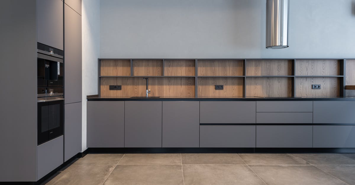 Popping corn on an electric stove - Spacious kitchen in modern apartment Popping corn on an electric stove - Spacious kitchen in modern apartment
