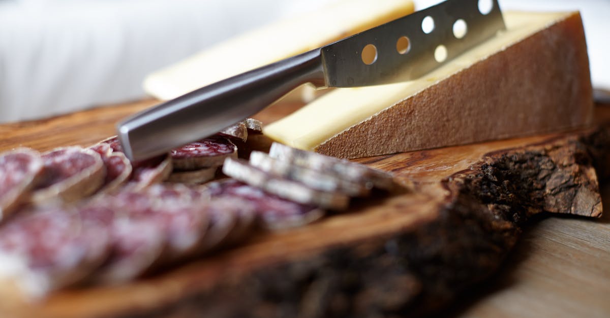Pork sausage - difference in food guidelines - Steel Knife on Chopping Board Pork sausage - difference in food guidelines - Steel Knife on Chopping Board