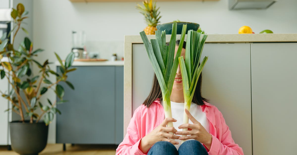 Possible dangers of home fermentation of vegetables - Smiling Woman Sitting on the Floor Covering Face With Leeks Possible dangers of home fermentation of vegetables - Smiling Woman Sitting on the Floor Covering Face With Leeks