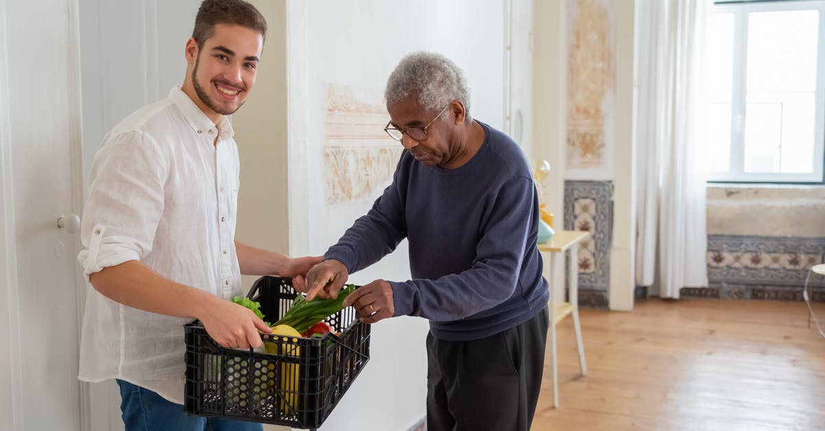 Possible dangers of home fermentation of vegetables - A Man Holding a Plastic Crater while Assisting an Elderly Man Possible dangers of home fermentation of vegetables - A Man Holding a Plastic Crater while Assisting an Elderly Man