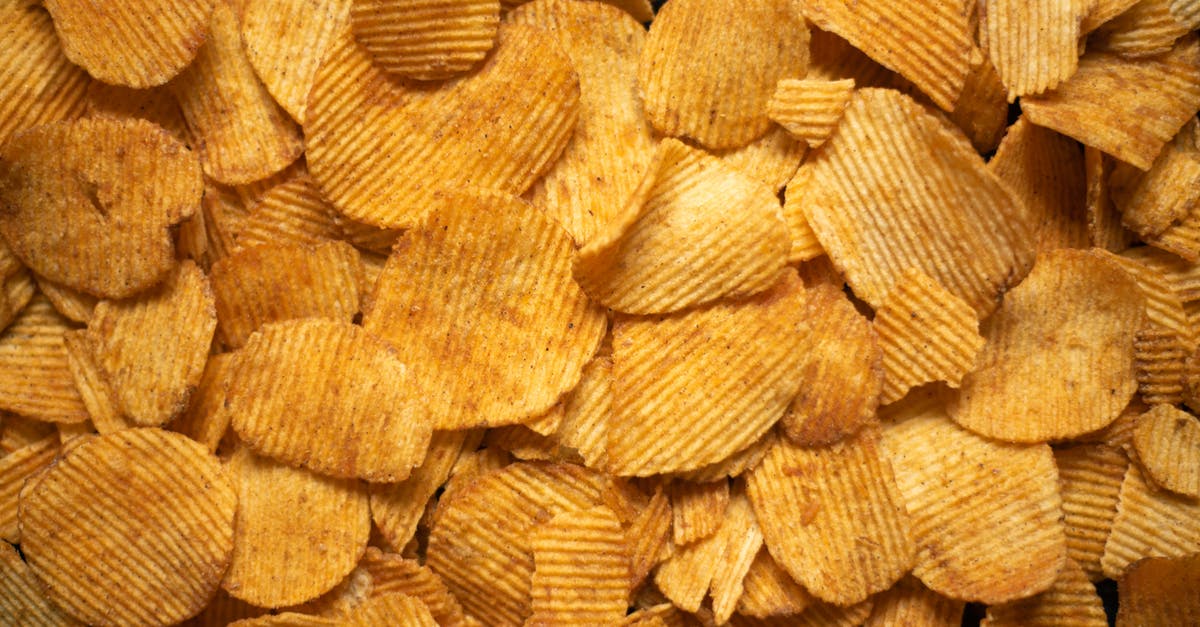 Potato chips lose crunch and taste within a week - Pile of scattered yummy potato chips Potato chips lose crunch and taste within a week - Pile of scattered yummy potato chips