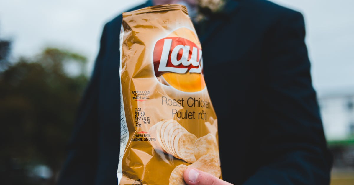 Potato chips lose crunch and taste within a week - Unrecognizable man with bag of chips Potato chips lose crunch and taste within a week - Unrecognizable man with bag of chips