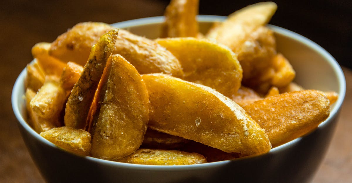 Potato Crisp making - Close Up Photo of Fried Potato Wedges Potato Crisp making - Close Up Photo of Fried Potato Wedges