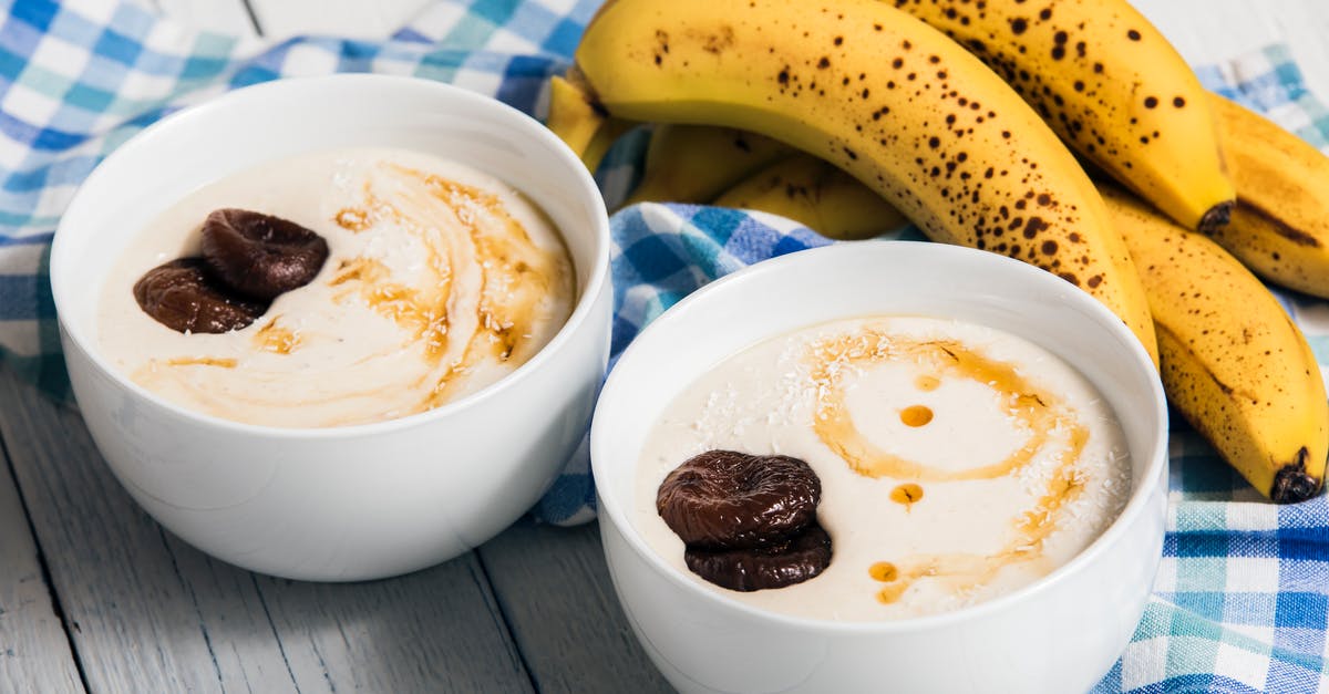 Premixed ingredients for yogurt - Bananas Beside Two White Bowls with Heavy Cream Premixed ingredients for yogurt - Bananas Beside Two White Bowls with Heavy Cream