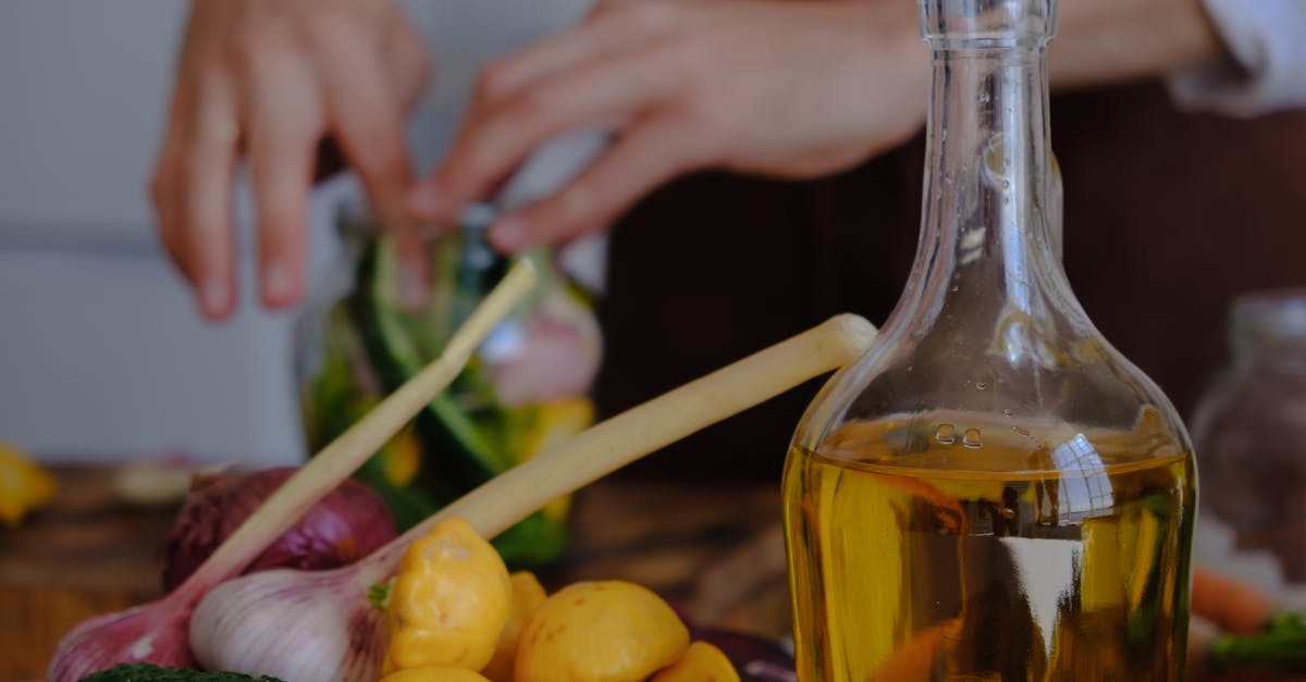 Preparation of gravlax versus lox - Clear Glass Bottle With Yellow Liquid Preparation of gravlax versus lox - Clear Glass Bottle With Yellow Liquid