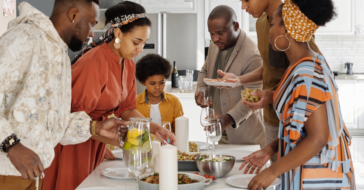Preparing dishes for photos - Family Setting the Table for Dinner Preparing dishes for photos - Family Setting the Table for Dinner