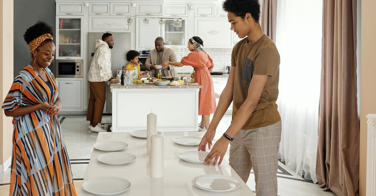 Preparing dishes for photos - Family Setting the Table for Dinner Preparing dishes for photos - Family Setting the Table for Dinner