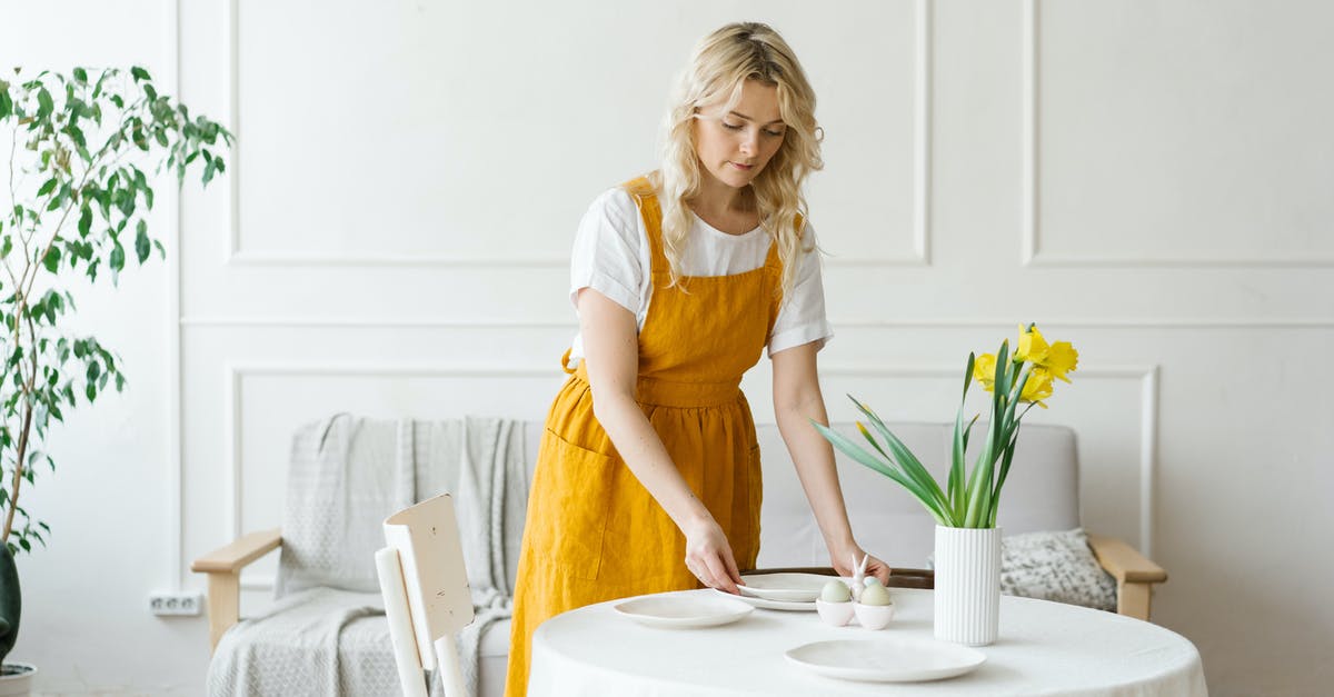 Preparing large cherrystone clams - Woman in Yellow Dress Sitting on White Chair Preparing large cherrystone clams - Woman in Yellow Dress Sitting on White Chair
