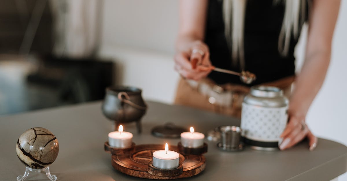 Preparing Salsa with a Magic Bullet - Woman preparing incense near shiny candles Preparing Salsa with a Magic Bullet - Woman preparing incense near shiny candles