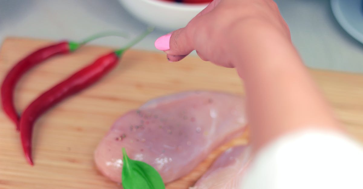 Preparing slow cooked meats for the next day - Person Pouring Condiment Preparing slow cooked meats for the next day - Person Pouring Condiment