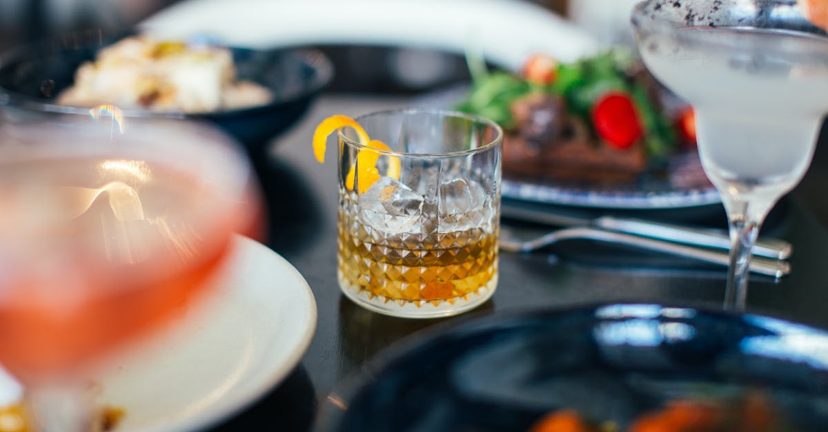 Preserved Lemons: is it ok if they are above the liquid - From above glasses of whiskey with ice cubes and lemon peel and vermouth with grapefruit placed on table near assorted dishes in restaurant Preserved Lemons: is it ok if they are above the liquid - From above glasses of whiskey with ice cubes and lemon peel and vermouth with grapefruit placed on table near assorted dishes in restaurant