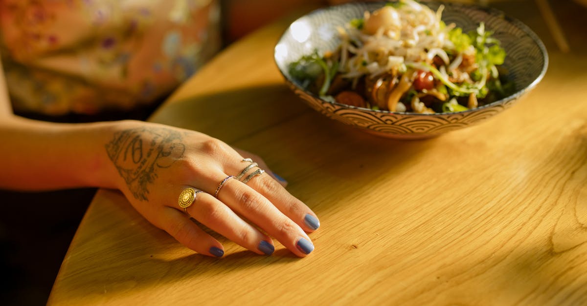 Preserving colour of vegetables in Chinese hakka noodles - Bowl of Noodles on Wooden Table Preserving colour of vegetables in Chinese hakka noodles - Bowl of Noodles on Wooden Table