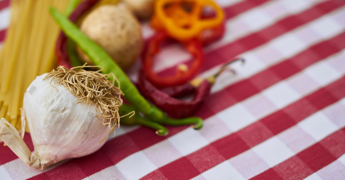 Preserving colour of vegetables in Chinese hakka noodles - Garlic on Red and White Gingham Textile Preserving colour of vegetables in Chinese hakka noodles - Garlic on Red and White Gingham Textile