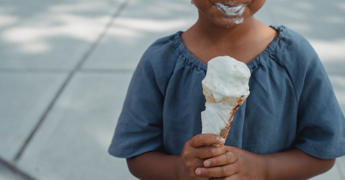 Preserving Nerds / Pop Rocks so they activate in the mouth and not in the food - Little child with dirty mouth standing with ice cream on street Preserving Nerds / Pop Rocks so they activate in the mouth and not in the food - Little child with dirty mouth standing with ice cream on street