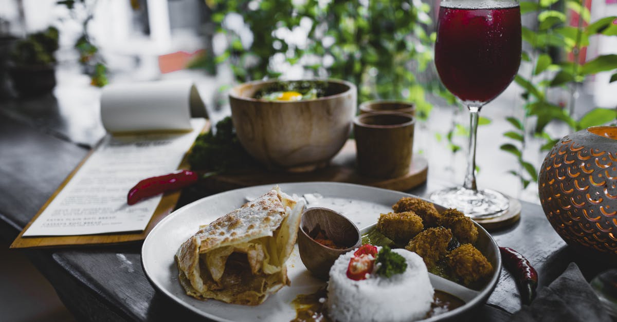 Pressure cooker rice quality vs high-end rice cooker - Plate with delicious Asian food and glass of refreshing beverage in cafe Pressure cooker rice quality vs high-end rice cooker - Plate with delicious Asian food and glass of refreshing beverage in cafe