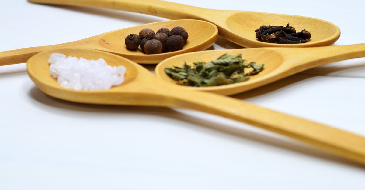 Pressure cooking beans with salt and spices - Four Brown Wooden Ladle Pressure cooking beans with salt and spices - Four Brown Wooden Ladle