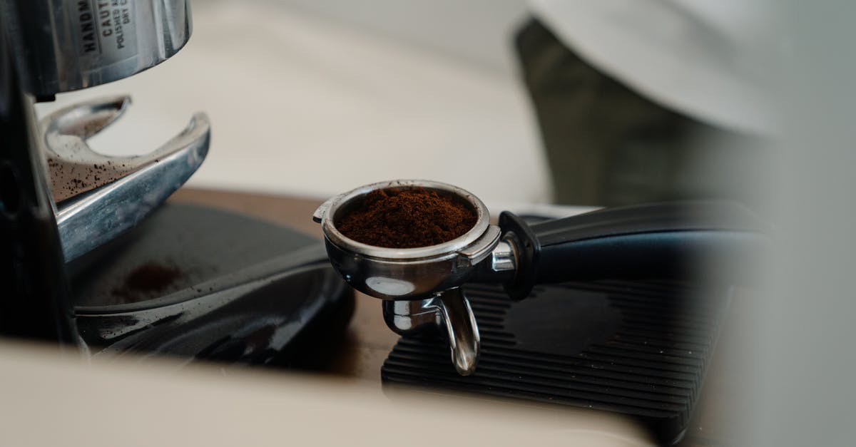 Prevent the grinder basket on Cuisinart coffee maker from sticking - Professional barista coffee making tools on wooden table Prevent the grinder basket on Cuisinart coffee maker from sticking - Professional barista coffee making tools on wooden table