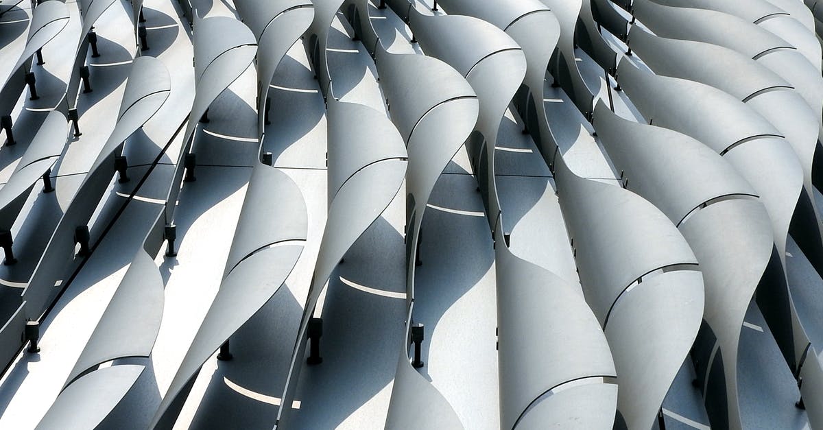 Prime Rib versus New York Strip Roast - Curved ribs of gray color on wall of futuristic building shining in daylight Prime Rib versus New York Strip Roast - Curved ribs of gray color on wall of futuristic building shining in daylight