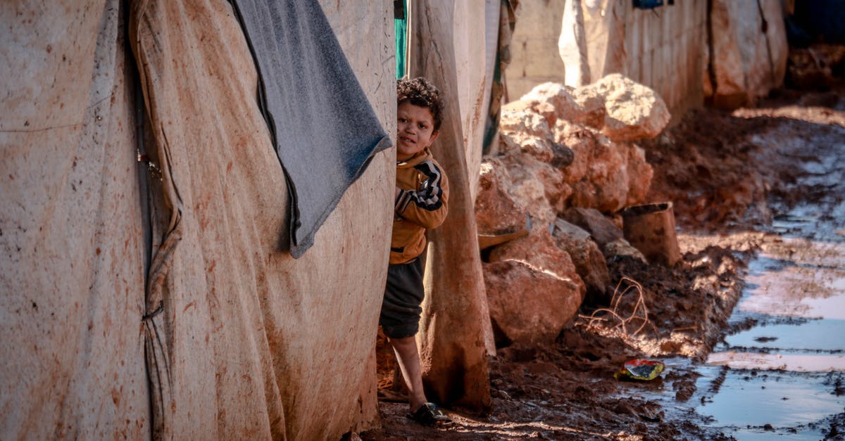 Problem Rolling Out Rough Puff Pastry - Little poor boy in muddy clothes looking at camera among old shabby brick houses with dirty fabric Problem Rolling Out Rough Puff Pastry - Little poor boy in muddy clothes looking at camera among old shabby brick houses with dirty fabric