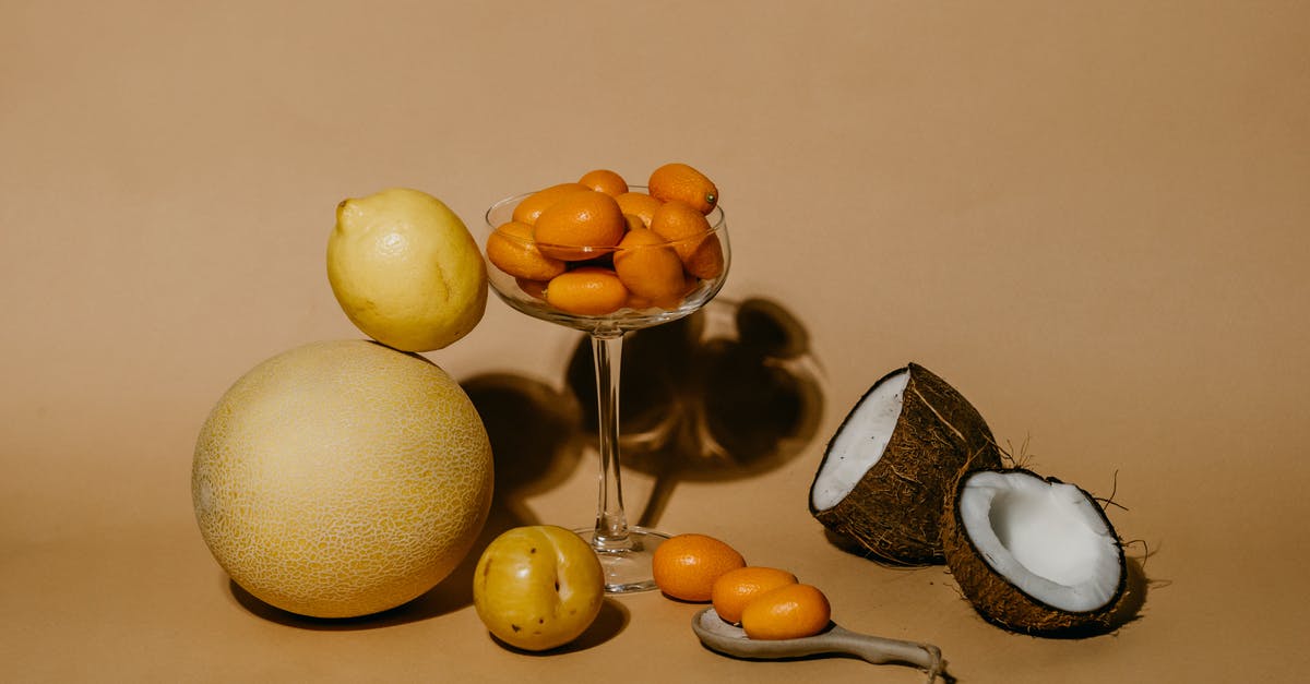 Prosciutto and Cantaloupe - A Bunch of Kumquats in Martini Glass Beside Citrus Fruits and a Sliced Coconut Prosciutto and Cantaloupe - A Bunch of Kumquats in Martini Glass Beside Citrus Fruits and a Sliced Coconut
