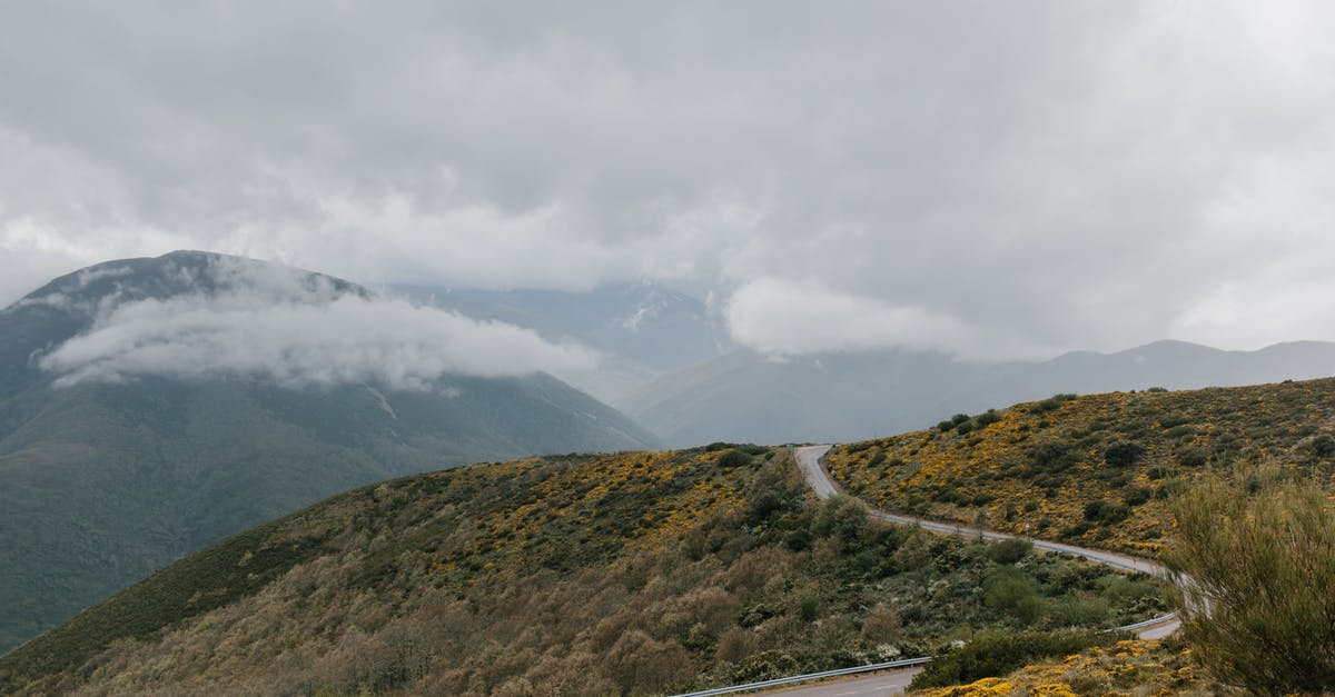 Pumpkin pie filling way too thick - Winding asphalt roadway running through grassy hill covered with grass and shrubs under cloudy sky Pumpkin pie filling way too thick - Winding asphalt roadway running through grassy hill covered with grass and shrubs under cloudy sky