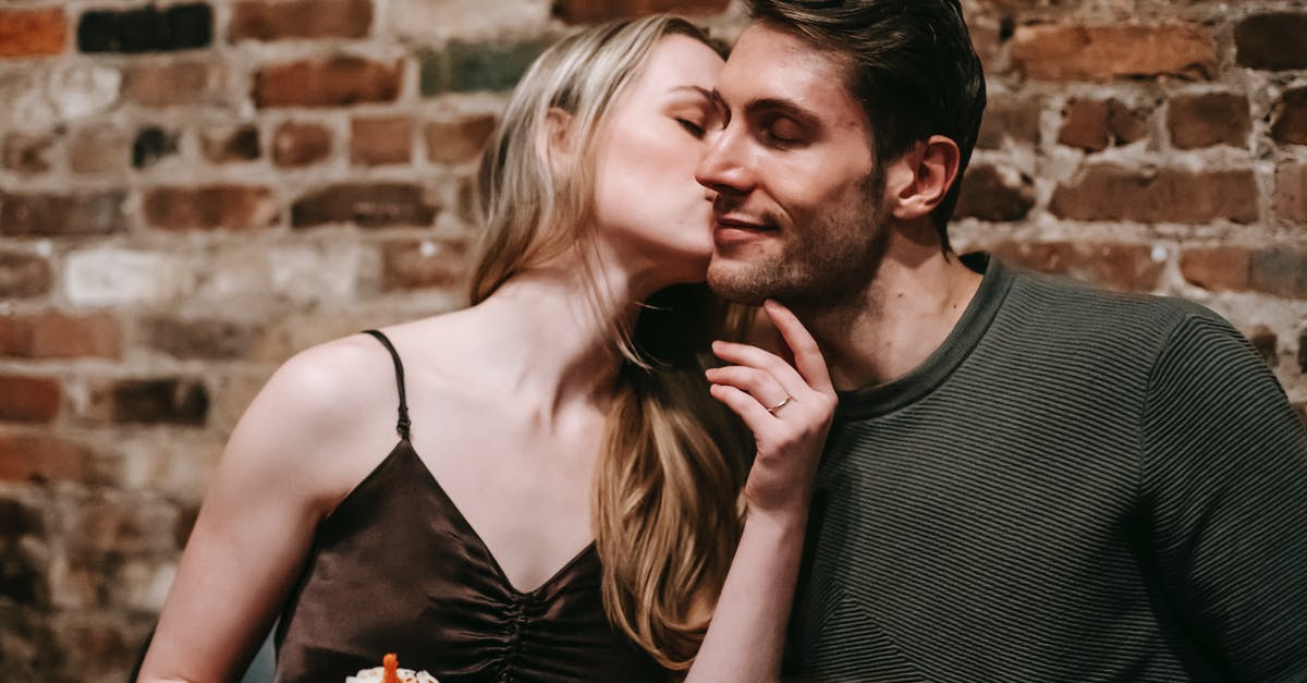 Putting a solid chocolate bar inside cake dough: what's the outcome? - Couple kissing while celebrating birthday with cupcake in restaurant Putting a solid chocolate bar inside cake dough: what's the outcome? - Couple kissing while celebrating birthday with cupcake in restaurant