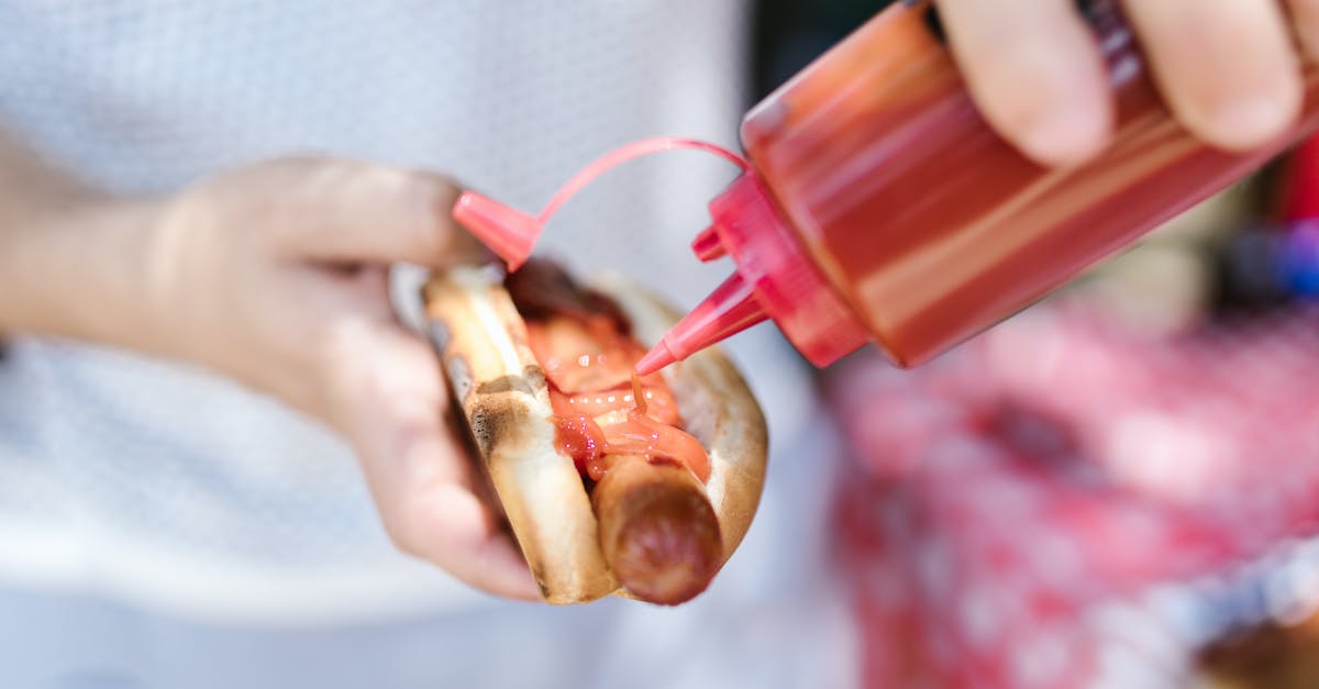 Putting cure in fry sausage? - A Person Putting Ketchup on the Hot Dog Putting cure in fry sausage? - A Person Putting Ketchup on the Hot Dog