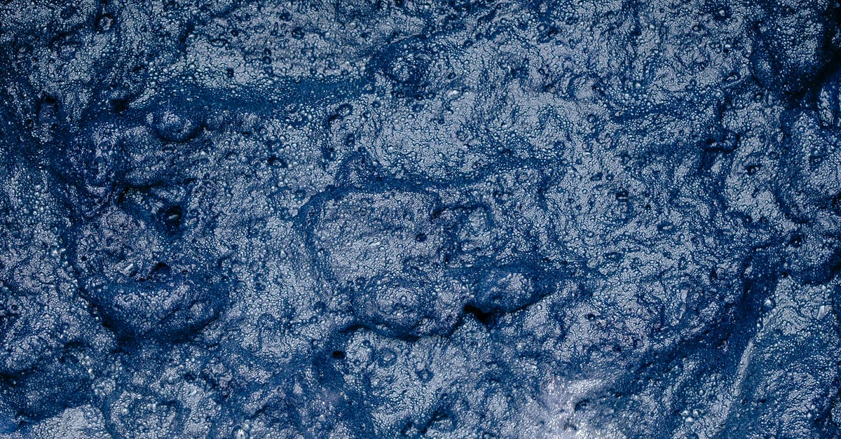 "Lime water" technique -- why use an excess of cal? - From above of surface of foamy indigo colored water during shibori tie dyeing process as abstract background "Lime water" technique -- why use an excess of cal? - From above of surface of foamy indigo colored water during shibori tie dyeing process as abstract background