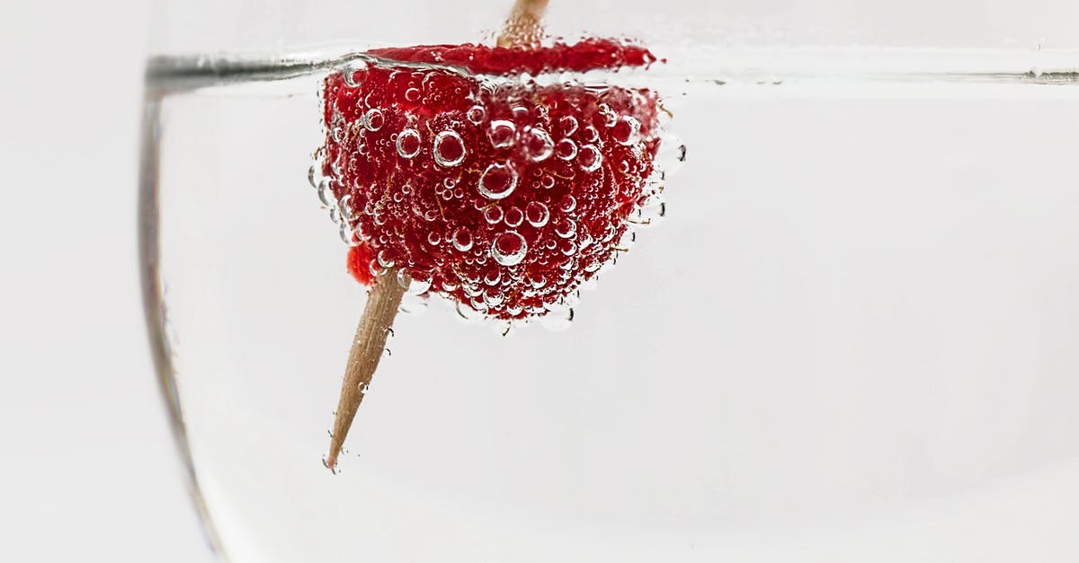Raspberry Infused Vodka - Red Raspberry on Water With Brown Stick