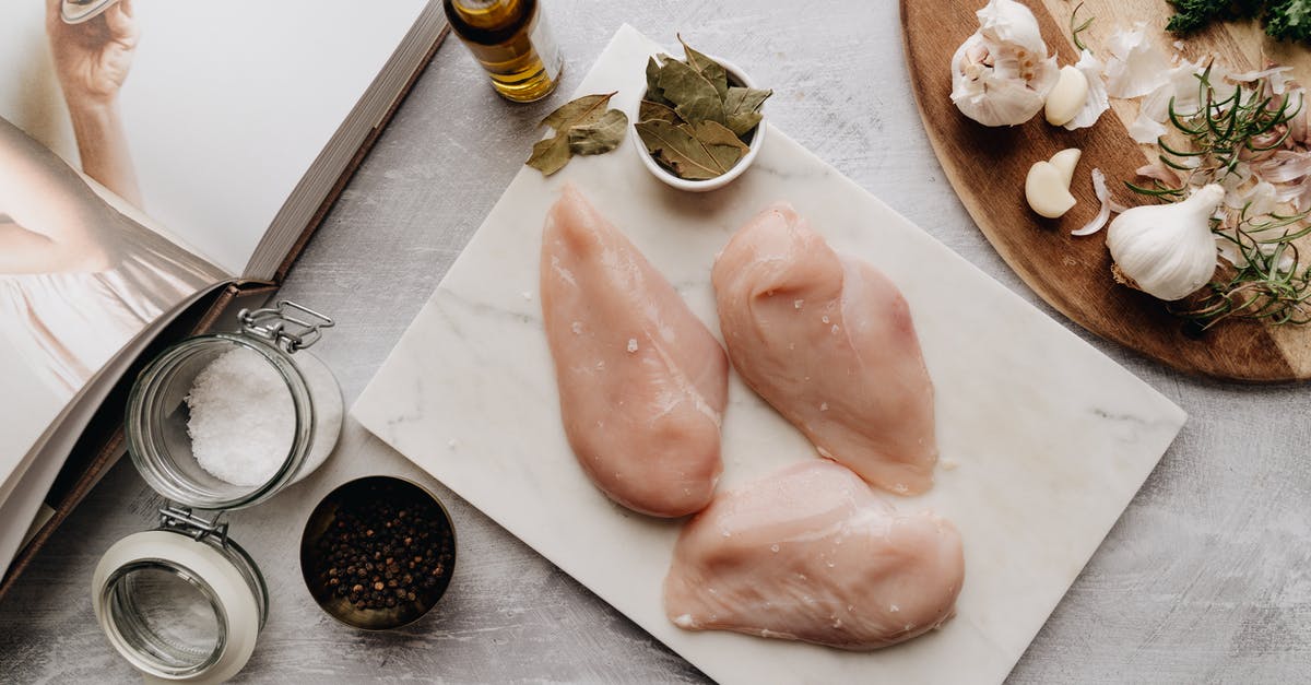 Raw garlic in Sunflower oil - Raw Meat on Chopping Board Raw garlic in Sunflower oil - Raw Meat on Chopping Board