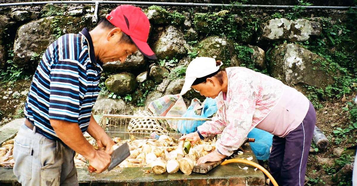 Raw Kale - Korean side dish - Ethnic workers preparing food in street Raw Kale - Korean side dish - Ethnic workers preparing food in street