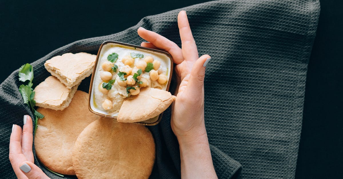 Reason for thickness of pepper\eggplant paste - Photograph of a Person's Hands Near Hummus and Bread Reason for thickness of pepper\eggplant paste - Photograph of a Person's Hands Near Hummus and Bread