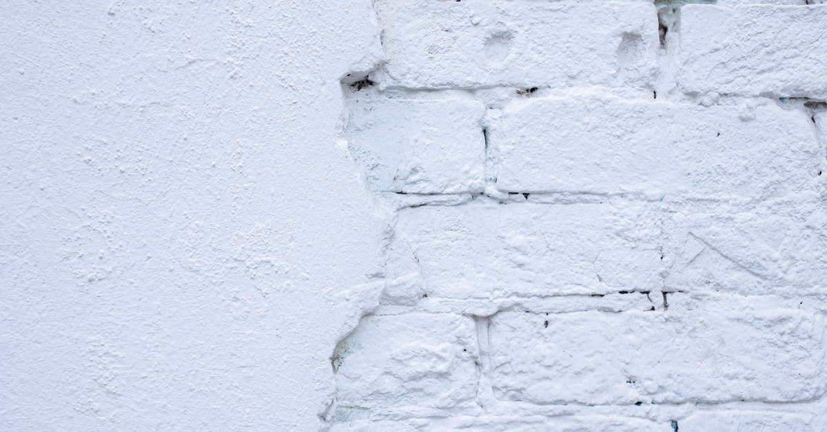 Recovering old wok with unknown lining - Rough white wall of bricks and plaster Recovering old wok with unknown lining - Rough white wall of bricks and plaster