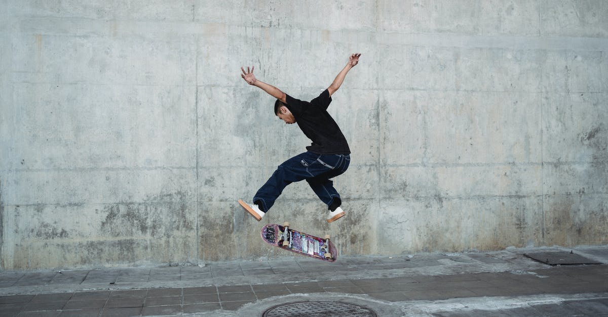Recreating New York street vendors' "halal chicken over rice" - Young man jumping with skateboard above manhole near concrete wall Recreating New York street vendors' "halal chicken over rice" - Young man jumping with skateboard above manhole near concrete wall